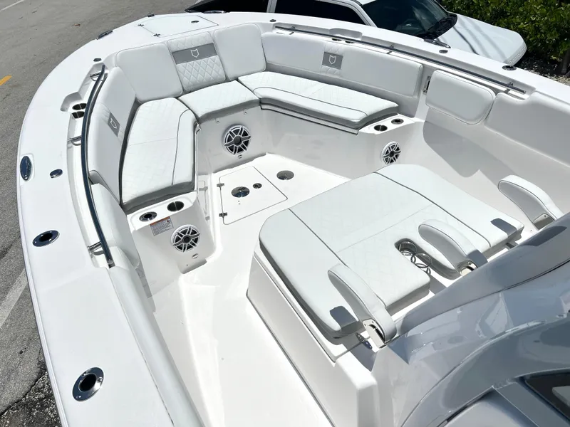 Slide: The Image of 2025 Sea Fox 328 Commander boat with white cushioned seating and built-in speakers. - 17