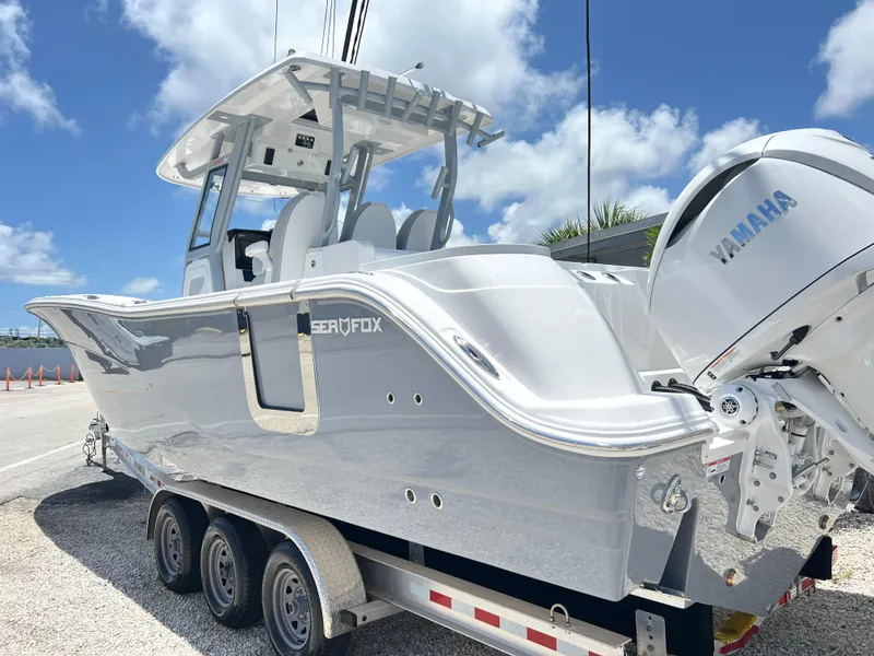Slide: The Image of 2025 Sea Fox 328 Commander boat on a trailer, featuring Yamaha engines. - 2