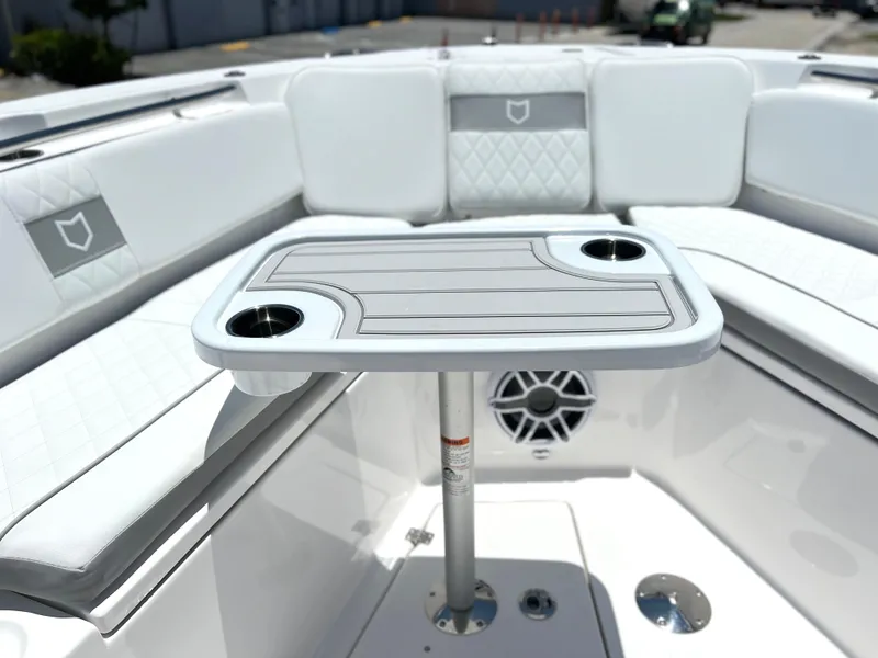 Slide: The Image of 2025 Sea Fox 328 Commander boat interior with cushioned seating and table. - 21