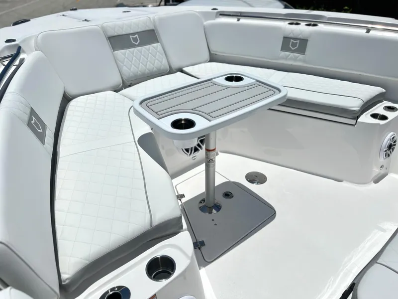 Slide: The Image of 2025 Sea Fox 328 Commander boat with white cushioned seating and a central table. - 22