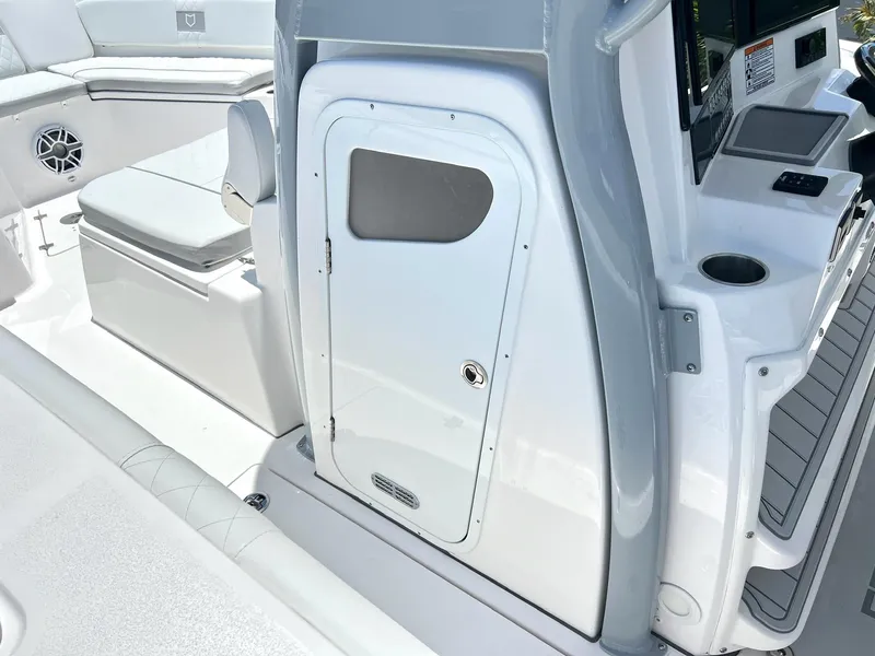 Slide: The Image of 2025 Sea Fox 328 Commander boat interior, featuring seating and storage compartments. - 31