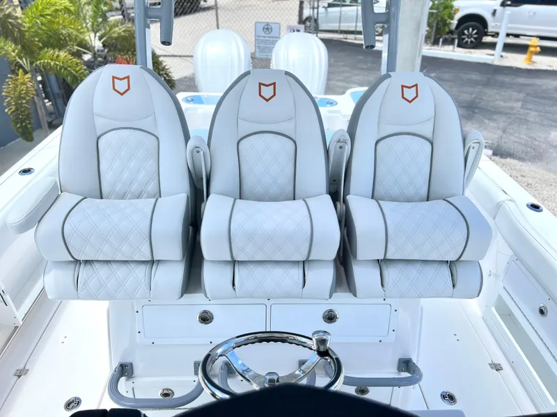 Slide: The Image of 2025 Sea Fox 328 Commander boat with luxurious white captain's chairs and steering wheel. - 44
