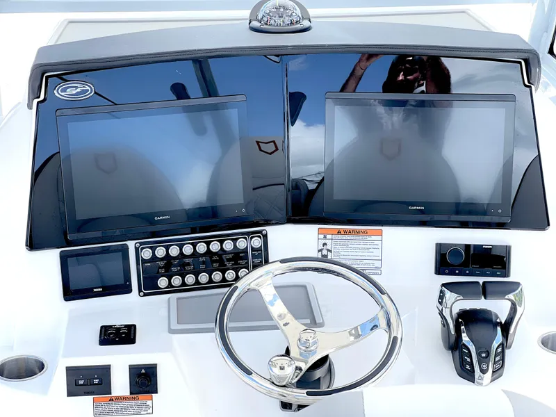 Slide: The Image of 2025 Sea Fox 328 Commander boat dashboard with dual Garmin screens and modern controls. - 49