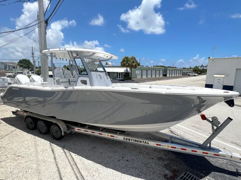 Slide: The Image of 2025 Sea Fox 328 Commander boat on a trailer under a clear blue sky. - 7