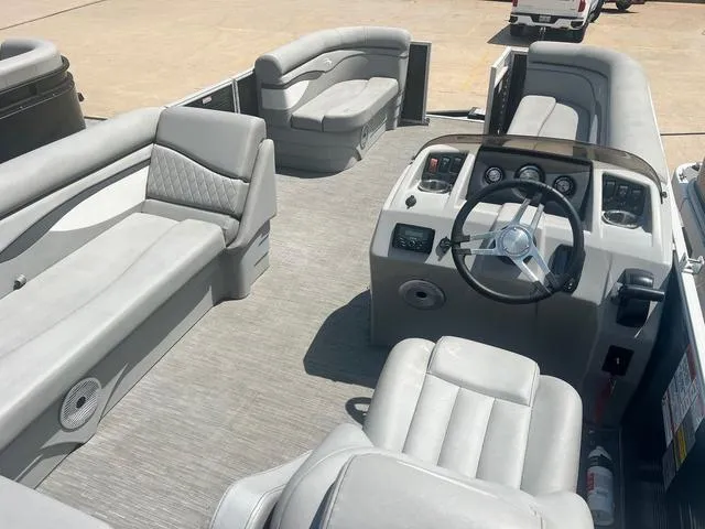Slide: The Image of 2023 Bennington 208 SL pontoon boat interior with gray seating and steering console. - 4