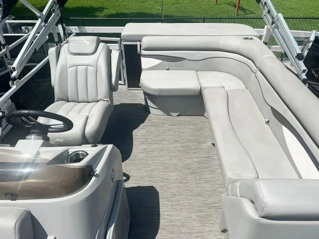 Slide: The Image of 2023 Bennington 208 SL boat interior with plush seating and steering console. - 5