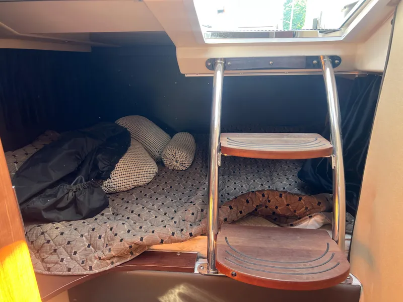 Slide: The Image of Interior cabin of 2012 Regal 28 Express boat with bed and wooden steps. - 17