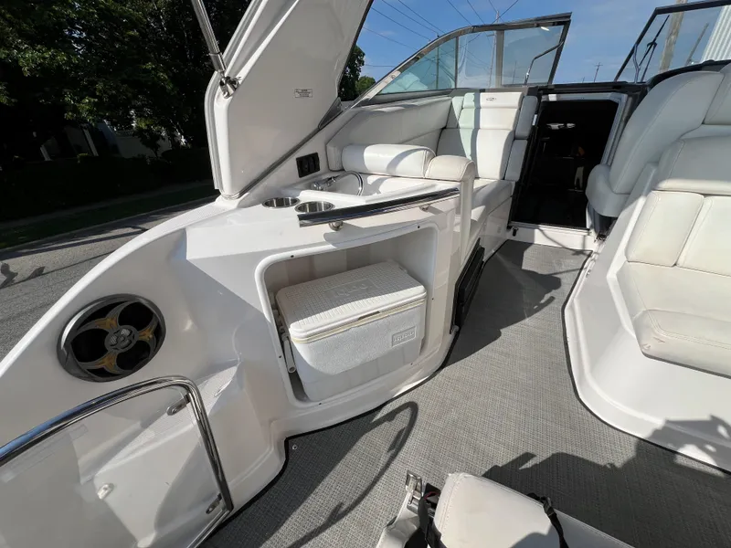 Slide: The Image of 2012 Regal 28 Express boat interior with seating, cooler, and speaker. - 24