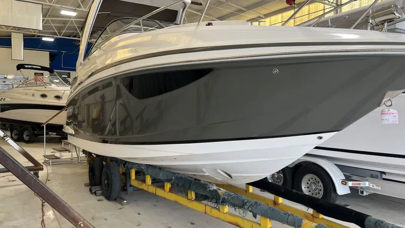 Slide: The Image of 2012 Regal 28 Express boat in indoor storage facility, side view. - 29