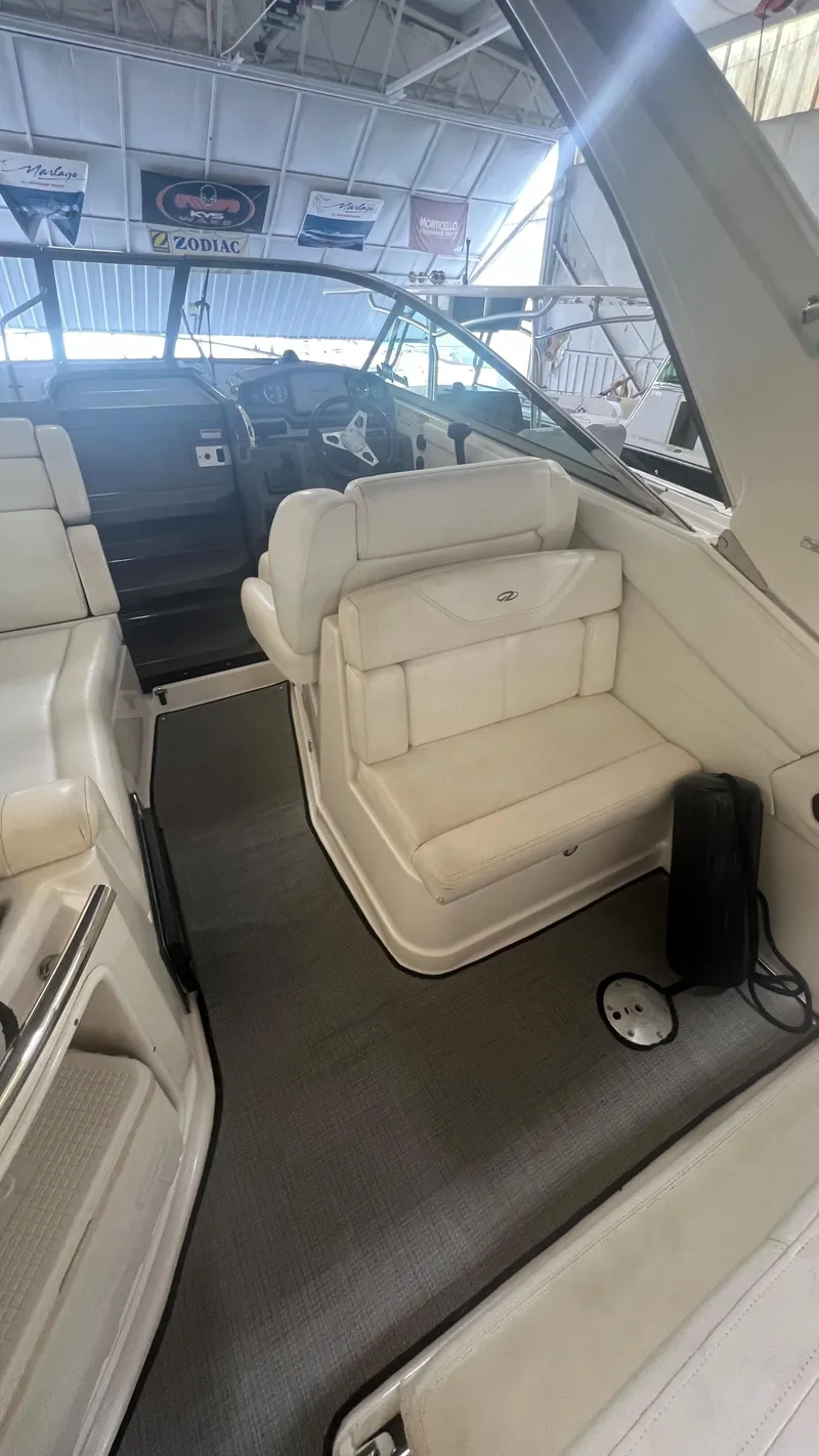 Slide: The Image of Interior of 2012 Regal 28 Express boat with white seating and steering area. - 36