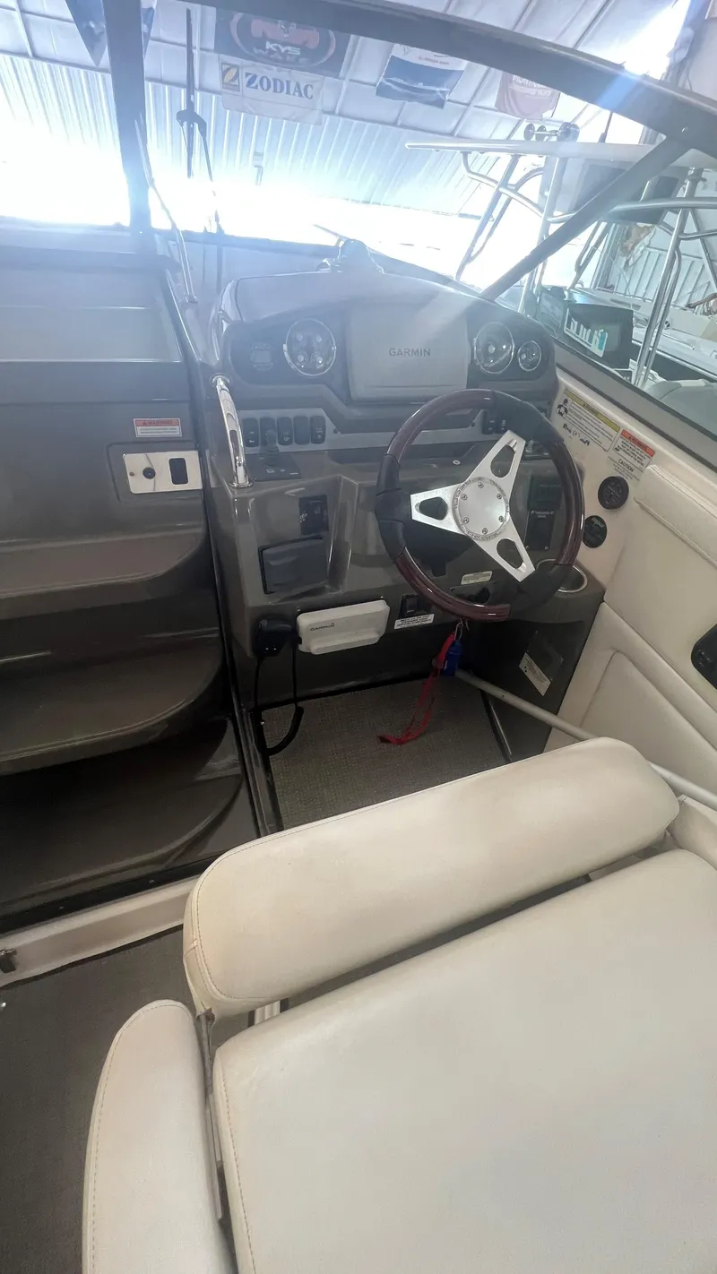 Slide: The Image of Interior view of 2012 Regal 28 Express boat cockpit with steering wheel and controls. - 37