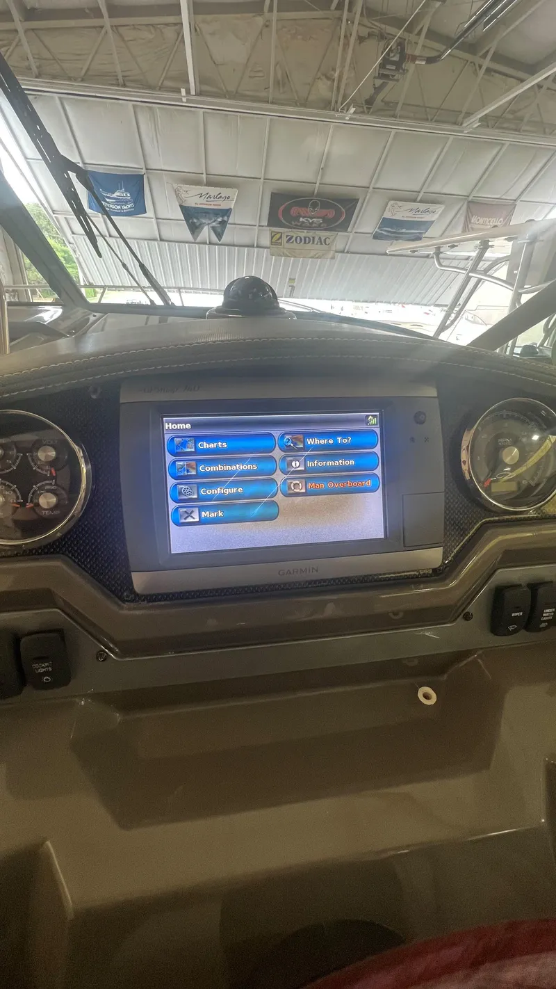 Slide: The Image of Control panel of a 2012 Regal 28 Express boat with navigation display. - 38