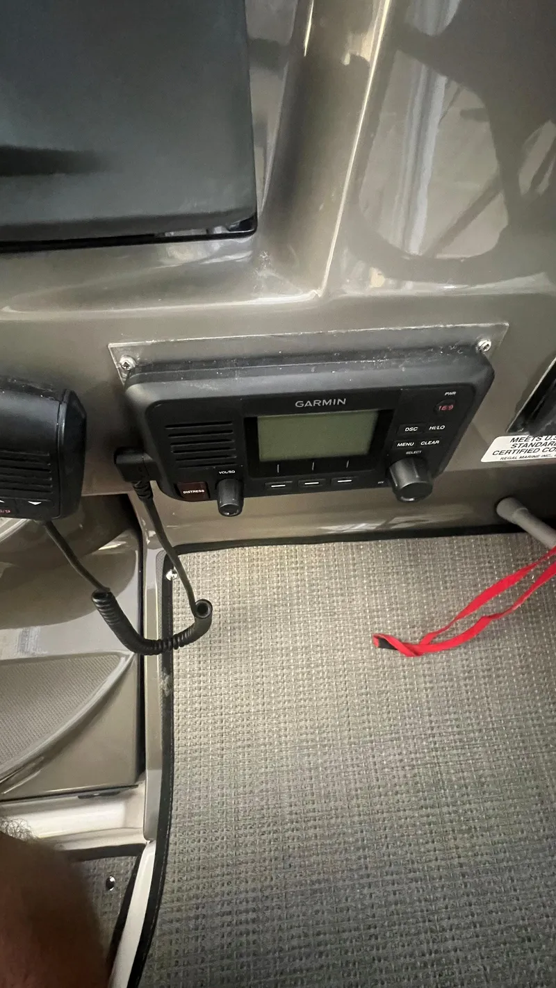 Slide: The Image of Garmin marine radio on 2012 Regal 28 Express boat dashboard, gray interior. - 39