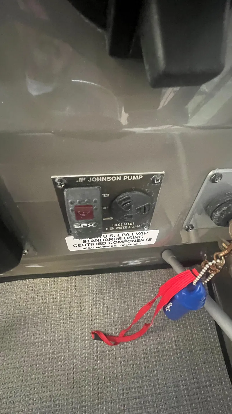 Slide: The Image of Control panel of a 2012 Regal 28 Express boat with Johnson pump and keychain. - 40