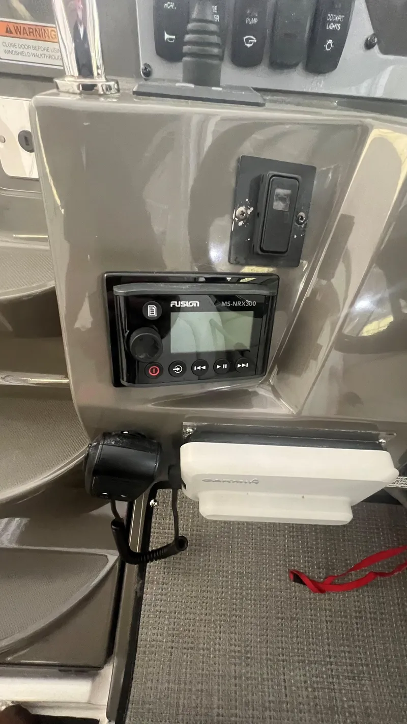 Slide: The Image of Control panel of a 2012 Regal 28 Express boat featuring a Fusion MS-RA70N stereo system. - 41