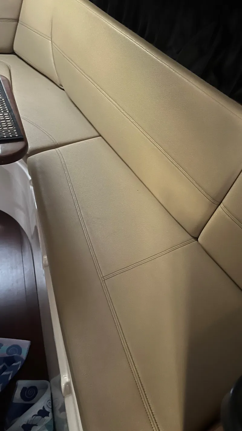 Slide: The Image of Beige leather seating inside a 2012 Regal 28 Express boat cabin. - 44