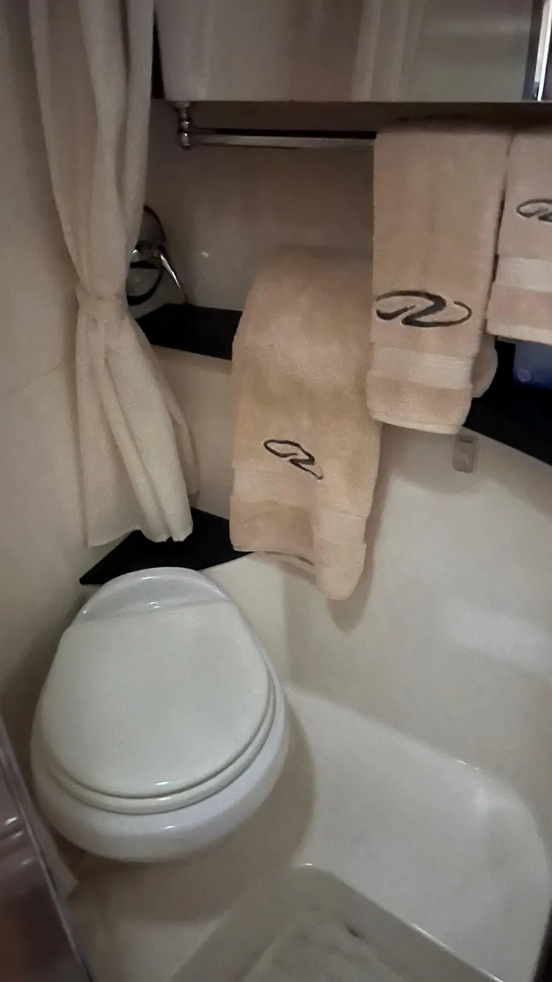 Slide: The Image of Bathroom interior of 2012 Regal 28 Express boat with towels and toilet. - 45