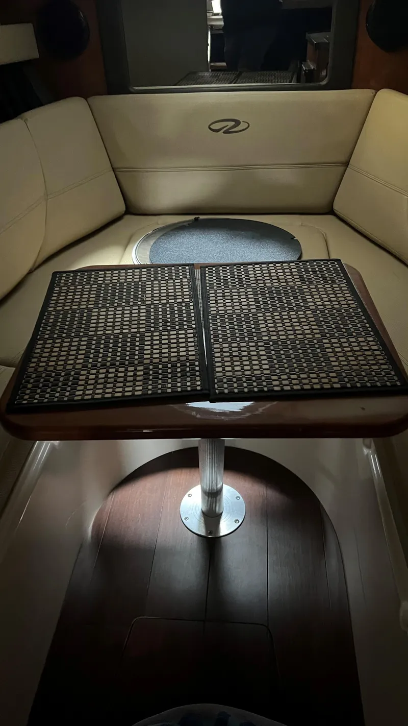 Slide: The Image of Interior of 2012 Regal 28 Express boat with seating and table. - 47