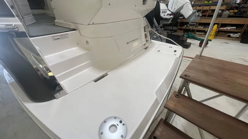 Slide: The Image of 2012 Regal 28 Express boat stern with wooden steps in a workshop setting. - 49