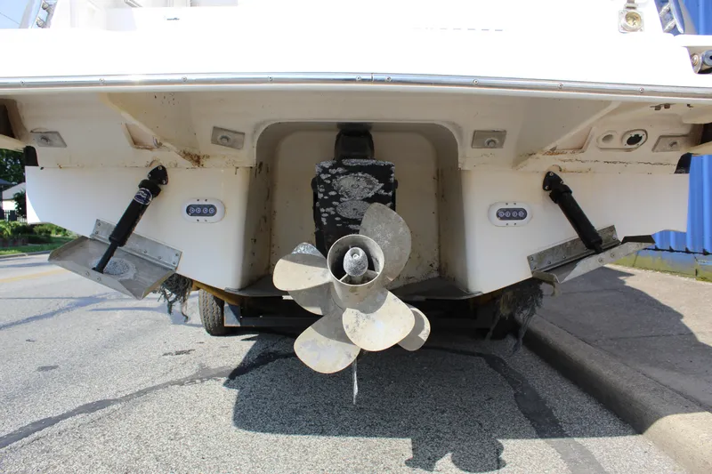 Slide: The Image of Rear view of a 2012 Regal 28 Express boat showing propeller and trim tabs. - 7