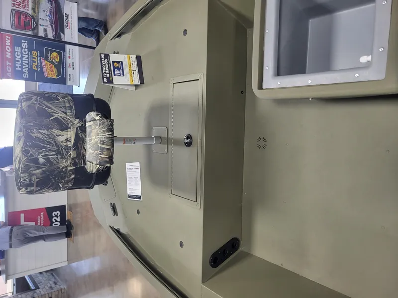 Slide: The Image of 2024 Tracker Grizzly 1754 SC boat interior with camo seat and storage compartments. - 3