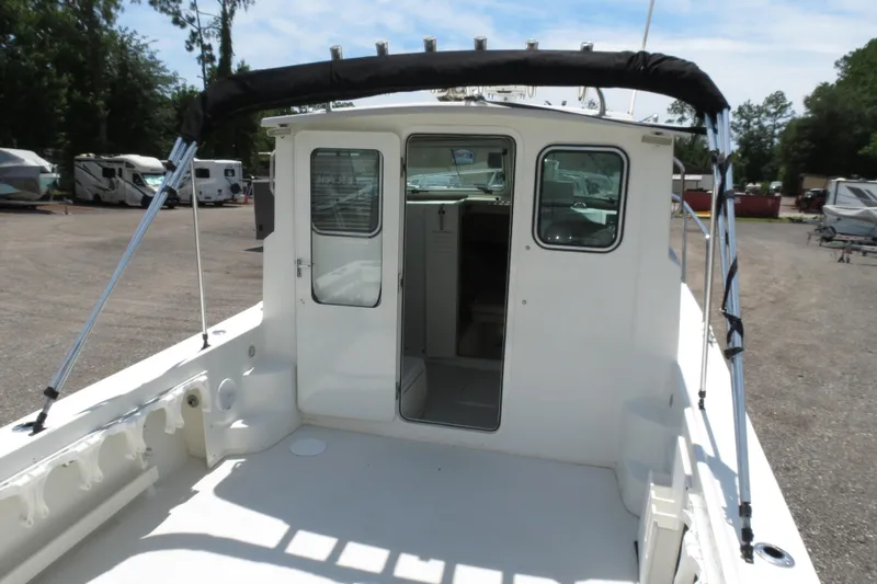 Slide: The Image of 2018 Parker 2520 XLD Sport Cabin boat, rear view with open cabin door. - 16
