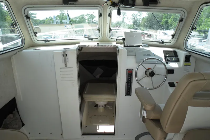 Slide: The Image of 2018 Parker 2520 XLD Sport Cabin interior with steering wheel and navigation equipment. - 18
