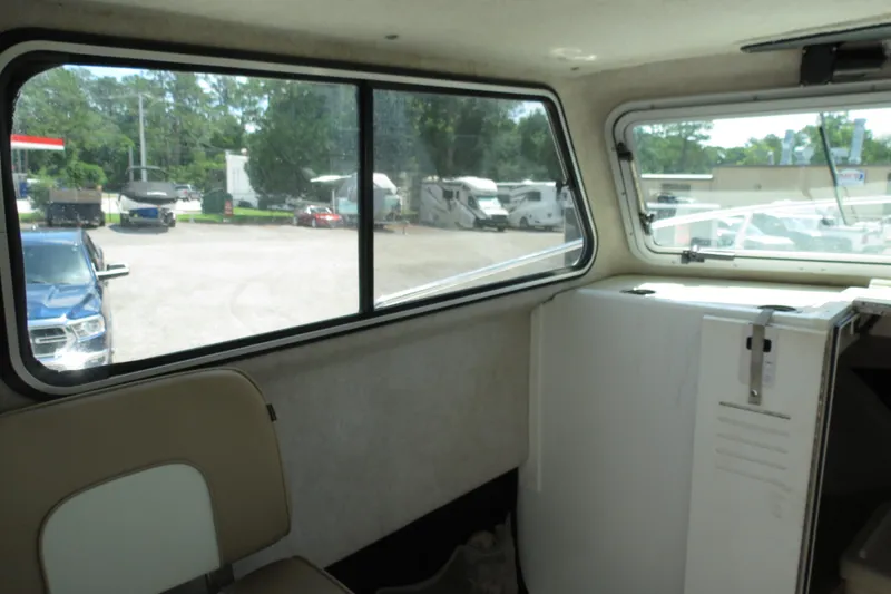 Slide: The Image of Interior view of 2018 Parker 2520 XLD Sport Cabin boat with window and seating. - 22