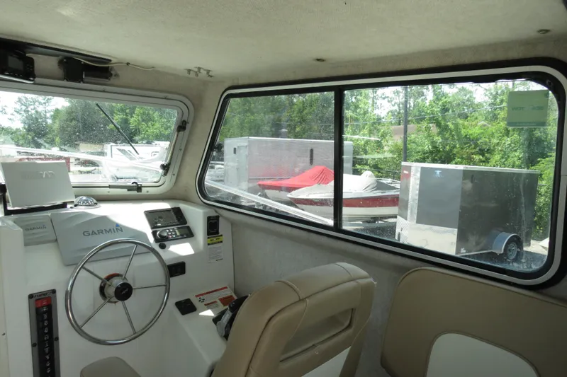 Slide: The Image of Interior of 2018 Parker 2520 XLD Sport Cabin boat with steering wheel and Garmin navigation. - 23