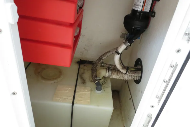 Slide: The Image of 2018 Parker 2520 XLD Sport Cabin storage compartment with water tank and pump. - 28