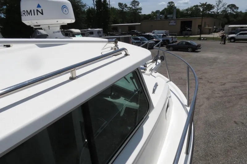 Slide: The Image of 2018 Parker 2520 XLD Sport Cabin boat with Garmin radar in a parking lot. - 41