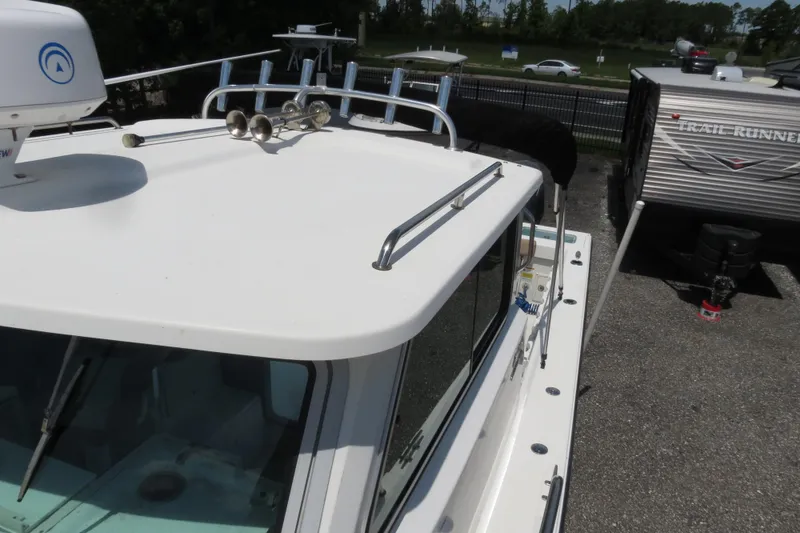 Slide: The Image of 2018 Parker 2520 XLD Sport Cabin boat top view with radar and railings. - 45