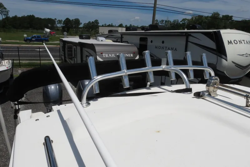 Slide: The Image of 2018 Parker 2520 XLD Sport Cabin boat roof with rod holders, parked near RVs. - 46