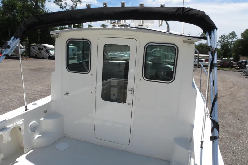 Slide: The Image of 2018 Parker 2520 XLD Sport Cabin boat rear view with door and windows. - 47