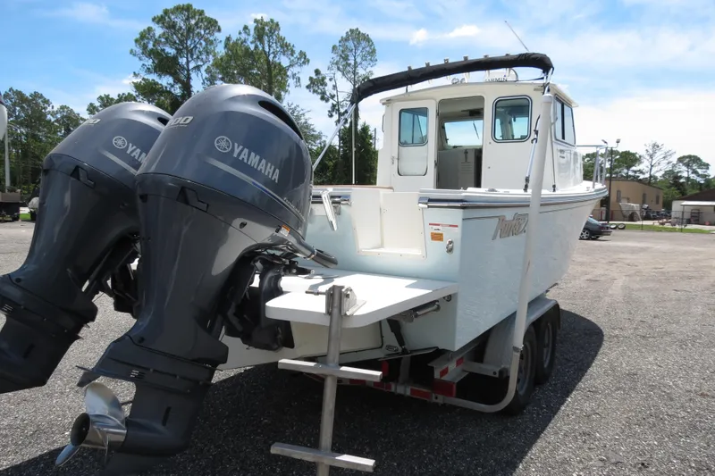 Slide: The Image of 2018 Parker 2520 XLD Sport Cabin boat with twin Yamaha outboard engines on trailer. - 5