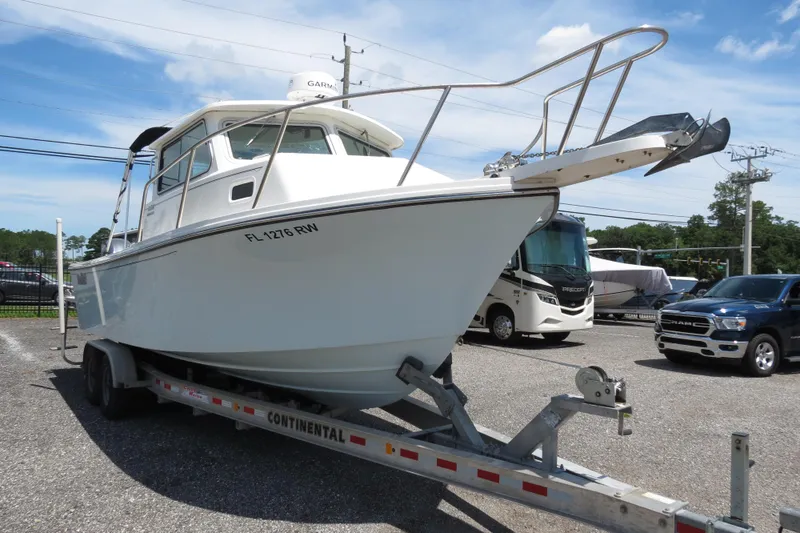 Slide: The Image of 2018 Parker 2520 XLD Sport Cabin boat on a Continental trailer in a parking lot. - 9