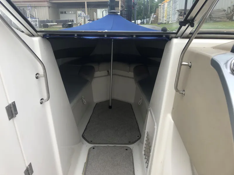 Slide: The Image of 2006 Larson 248 LXI boat interior with seating and carpeted floor. - 8