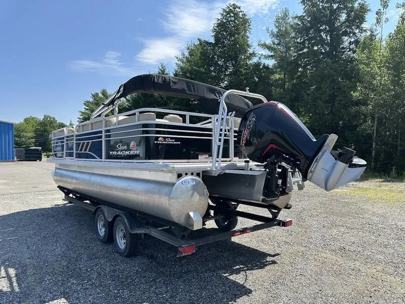 Slide: The Image of 2021 Sun Tracker PB 22 RF pontoon boat on trailer, parked outdoors. - 10