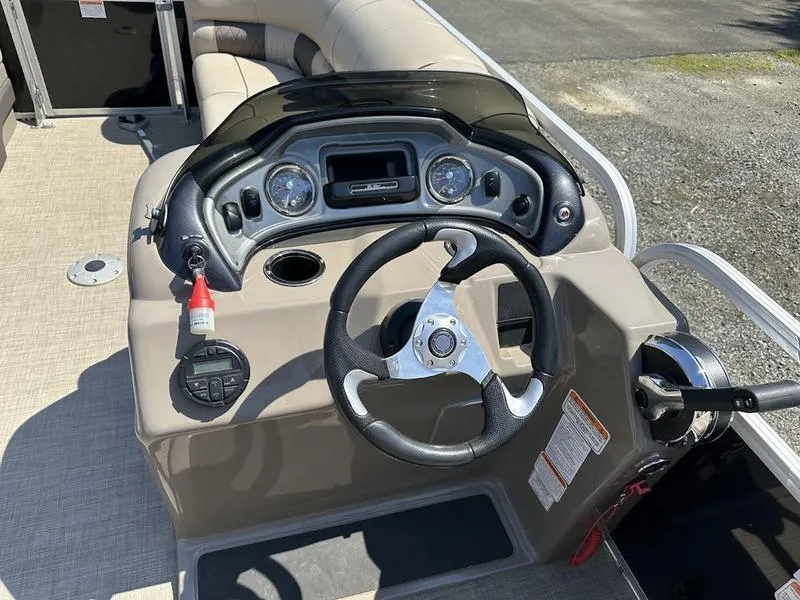 Slide: The Image of 2021 Sun Tracker PB 22 RF boat dashboard with steering wheel and controls. - 11