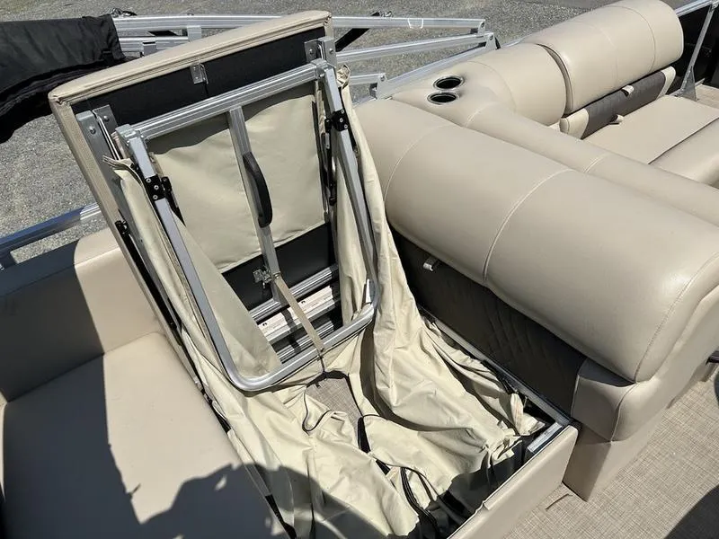 Slide: The Image of 2021 Sun Tracker PB 22 RF pontoon boat with open storage compartment and beige seating. - 14