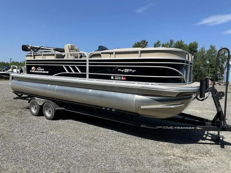 Slide: The Image of 2021 Sun Tracker PB 22 RF pontoon boat on trailer, parked outdoors. - 15