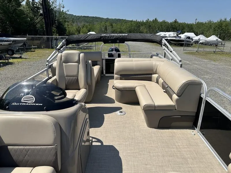 Slide: The Image of 2021 Sun Tracker PB 22 RF pontoon boat with beige seating and open deck. - 9