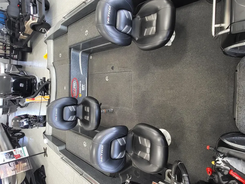 Slide: The Image of 2018 Nitro ZV21 boat interior with four black seats and fishing equipment. - 5