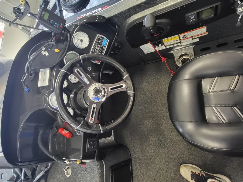 Slide: The Image of 2018 Nitro ZV21 boat dashboard and steering wheel with gauges and controls. - 6
