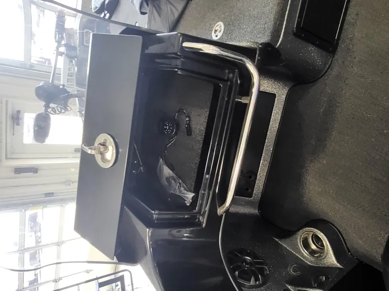 Slide: The Image of 2018 Nitro ZV21 boat storage compartment with open lid and lock. - 7