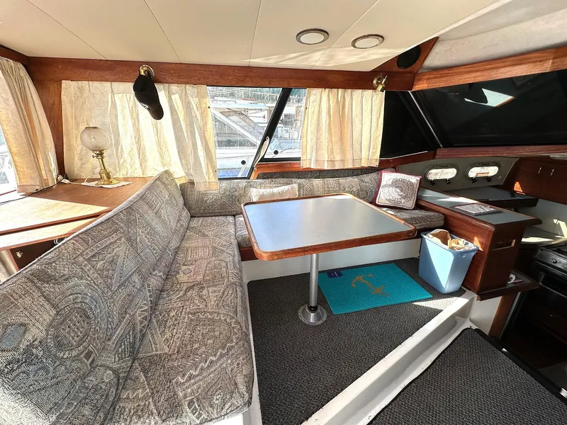 Slide: The Image of Interior of 1992 Bayliner 3288 with cozy seating and dining area. - 10