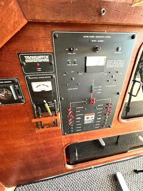 Slide: The Image of Control panel of a 1992 Bayliner 3288 boat, featuring electrical and tank monitoring systems. - 16