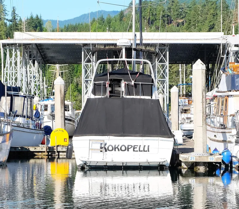 Slide: The Image of Bayliner 3288 boat named Kokopelli docked at marina, surrounded by other boats. - 2