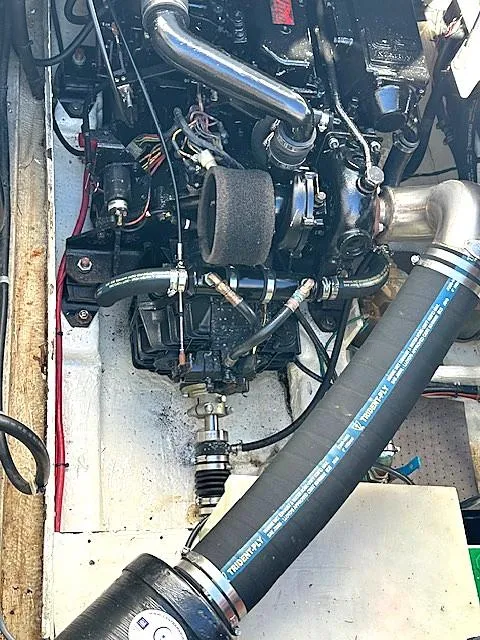Slide: The Image of Engine compartment of a 1992 Bayliner 3288 boat, showcasing mechanical components and hoses. - 23