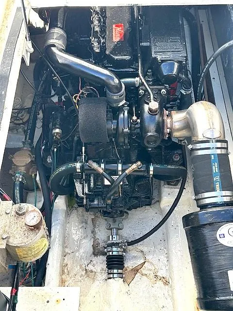 Slide: The Image of Engine compartment of a 1992 Bayliner 3288 boat, showcasing mechanical components and wiring. - 24